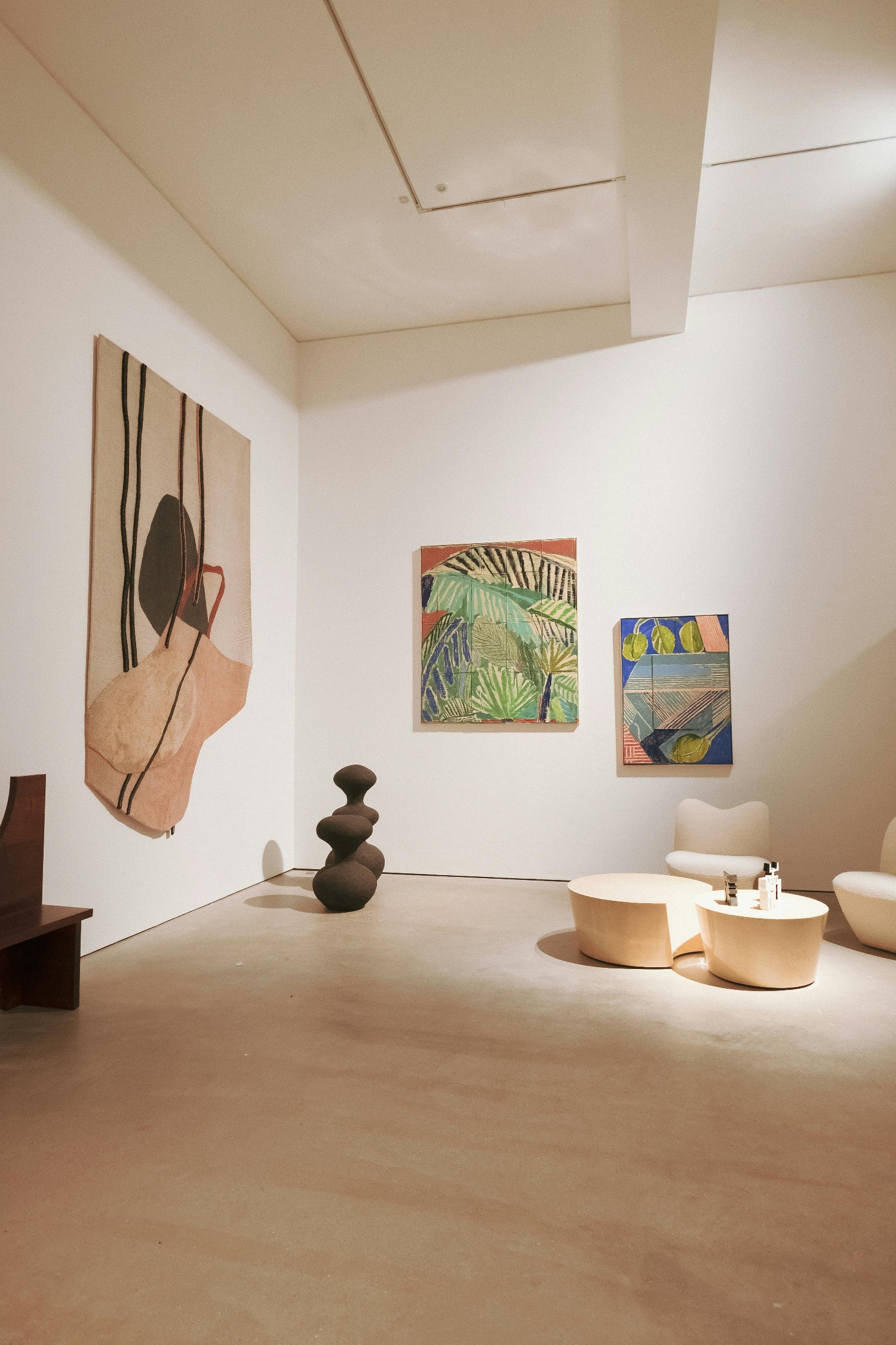 Modern interior with abstract art on walls and minimal furniture.